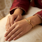 SJJGB114 | Swirl Elegance Designer Gold Bangle with Fluid Artistic Design